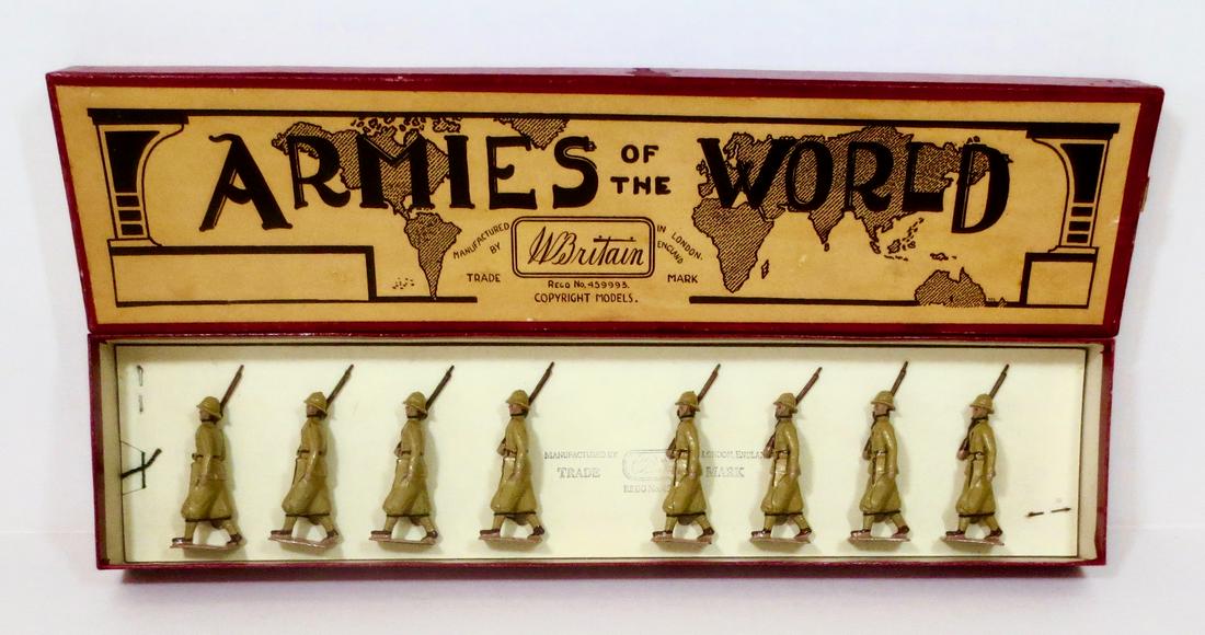 Britains #1436 Italian Infantry Colonial Service: Italian Infantry - colonial service dress, marching at the slope. 1938-41 issue, tied in Armies of The World box. Khaki (yellow) uniforms & pith helmets. 8 pieces. Near mint condition. Box excellent.