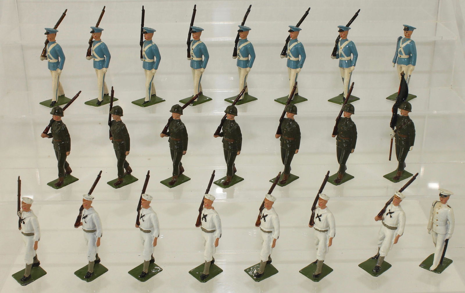 Britains Set #2100 Venezuelan Infantry Sailors: Venezuelan Display including Infantry, Sailors and Military School Cadets. Made 1955-59. 23 Pieces. Condition Fair to Excellent. Naval Officer Paint Touch-up and 2 Cadets Legs Crushed. No Box.