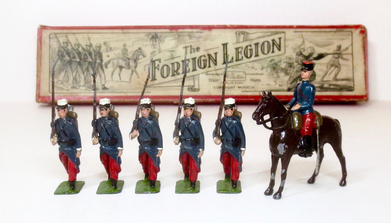 Britains #1711 French Foreign Legion: The French Foreign Legion with Mounted Officer. Post war in Illustrated box. 6 pieces (one figure missing). Excellent to very good condition. Box poor (top and bottom corner splits and top side tear).