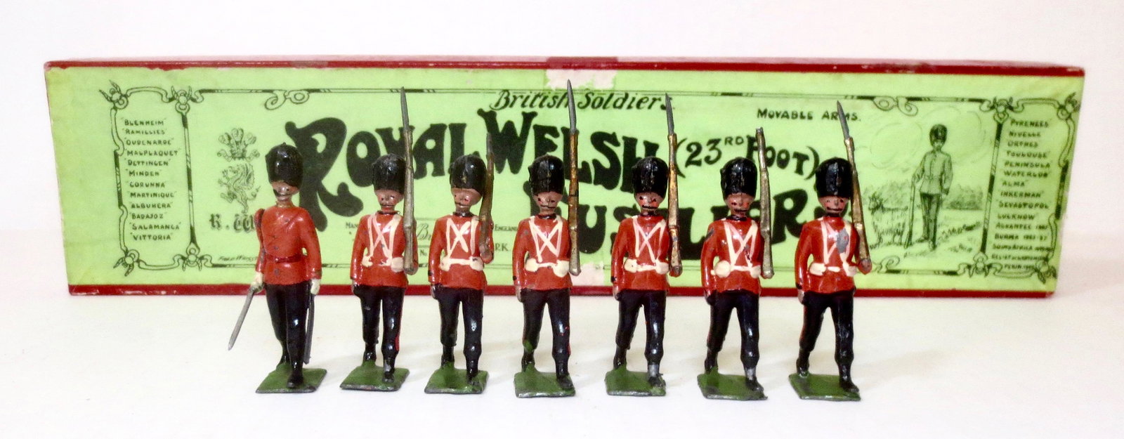 Britains #74 Royal Welsh Fusiliers: 23rd Foot. Pre war, in Whisstock label box. 7 pieces. Very good condition (one missing bayonet). Box very good (with a bit of surface wear on the top label).