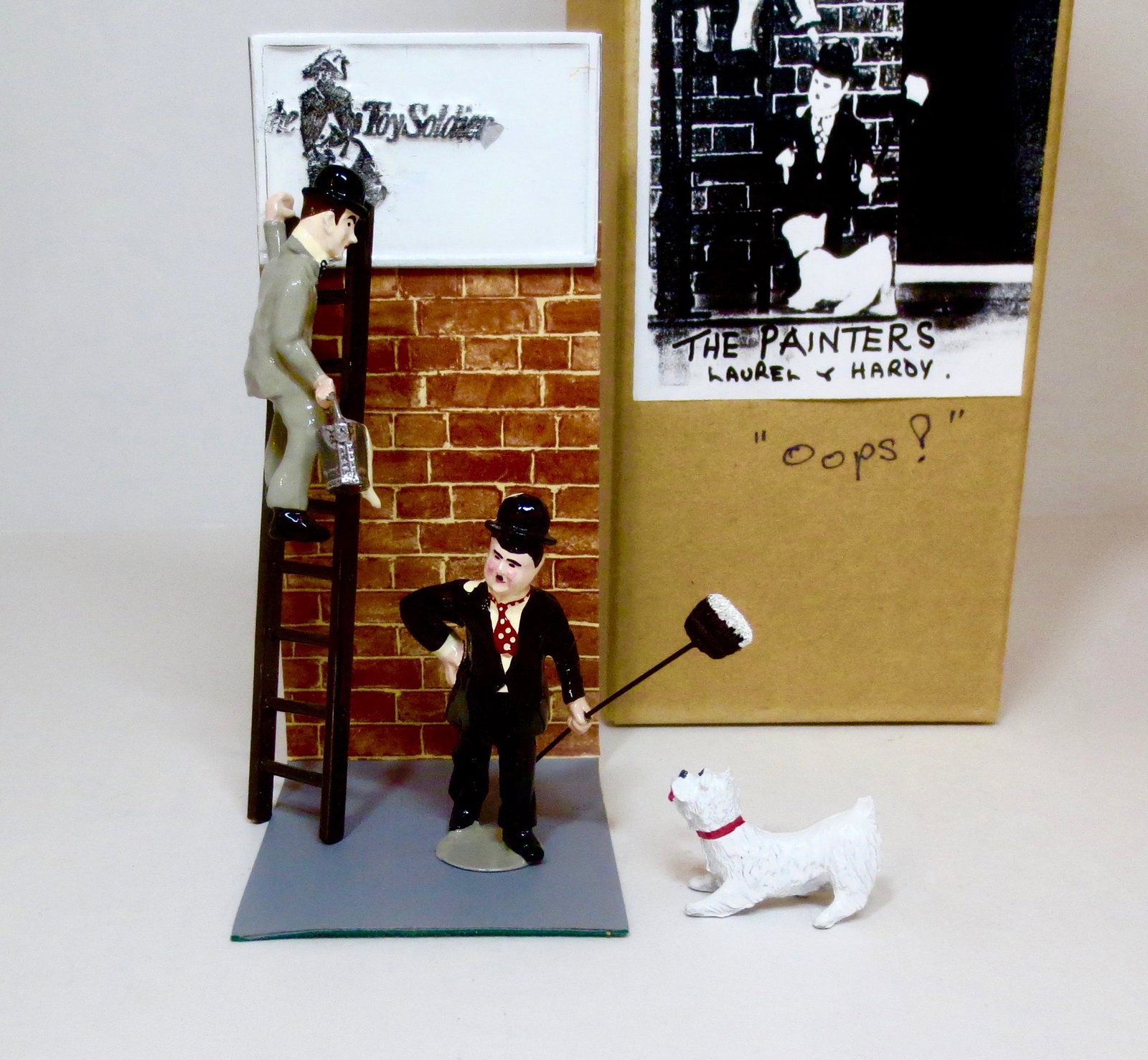 Laurel & Hardy "Oops" The Painters Set: From The Toy Soldier Shoppe. Captures the magic of the old Laurel & Hardy movies, with Stanley spilling paint on Ollie. 4 pieces. 60mm scale. Near mint in box. Box very good.