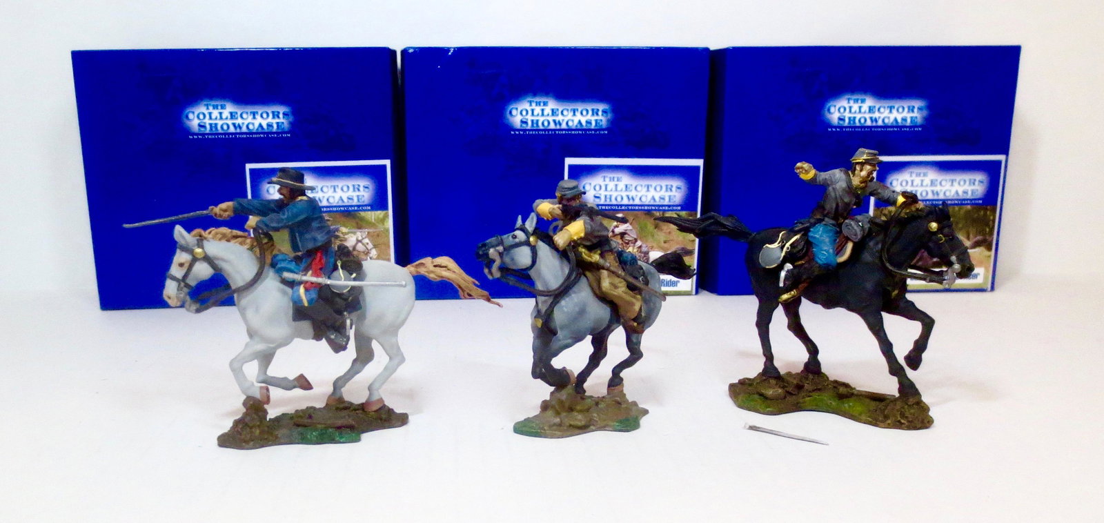 Collectors Showcase American Civil War: Confederate Officer (#CS00245), Confederate Rider (#CS00246), and Union Cavalry Commander (#CS00251). 3 pieces. Excellent to good condition (one with broken sword, included for repair). Boxes excellen