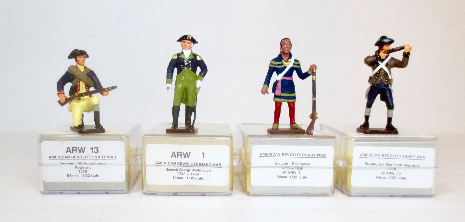 American Revolutionary War Assortment: George Washington, Iroquois, Private 2nd New York Regiment (broken rifle), Sergeant 7th Pennsylvania Regiment. 54 mm scale. 4 pieces. Excellent to very good condition. Plastic cases excellent.