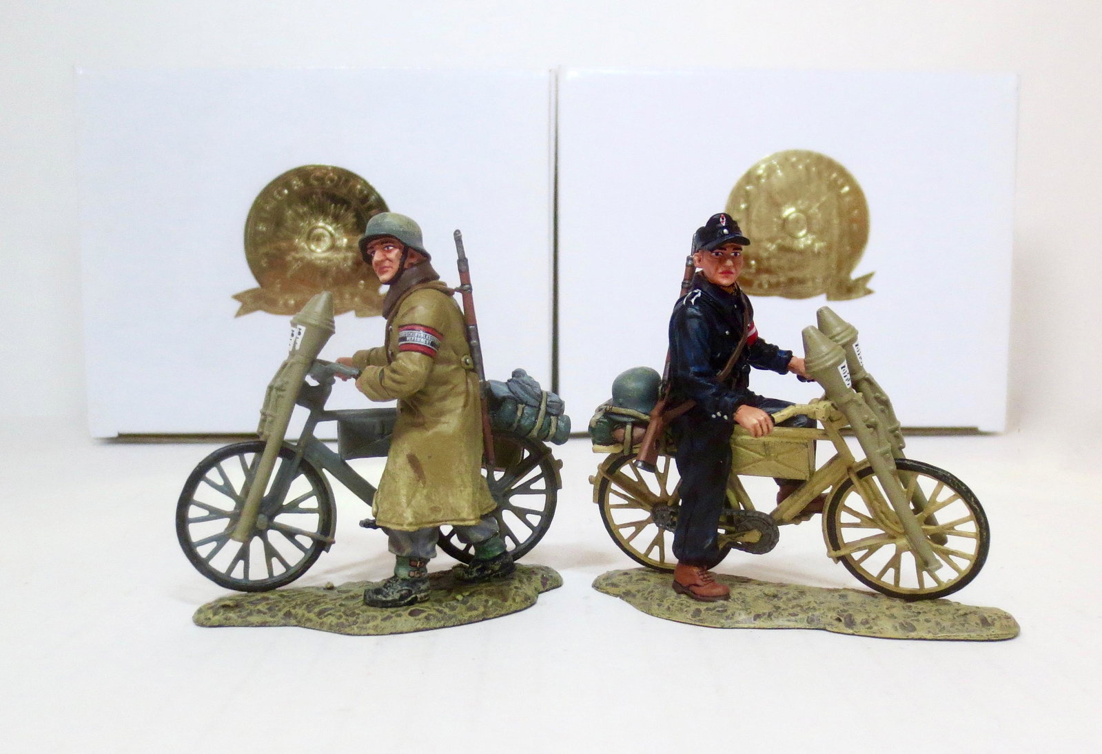 King & Country #WS191 & #WS192: Volksturm with Bicycle”, and “Hitlerjugend with Bicycle”. 2 pieces. Both retired. Near mint in boxes. Boxes excellent.
