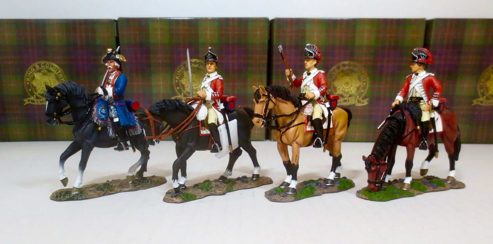 King & Country American Revolution Assortment: Cavalry Officer (#BR055), Cavalry with Rifle (#BR056), Cavalry with Sword (#BR057), Mounted Officer (#BR073). 4 pieces. Retired Figures. Near mint condition. Boxes excellent.