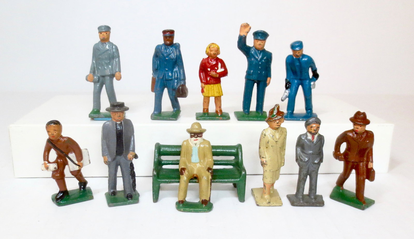 Grey Iron American Family Travels: Includes; "Train Ticketmaster", "Train Porter with Luggage", "Girl in Traveling Suit", "Train Conductor", "Train Engineer", "News Boy", "Preacher", "Grandpa on Park Bench", "Woman in Traveling Suit", 