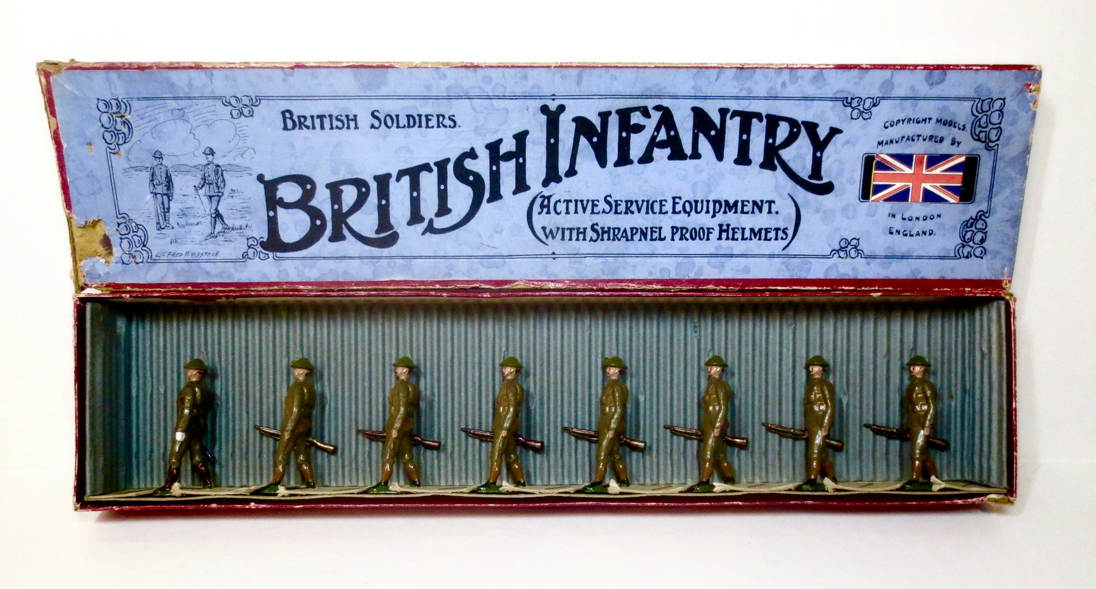 Britains #195 British Infantry: Marching at the Trail in Active Service Equipment with Shrapnel Proof Helmets. Pre war. Retied in Whisstock Box. 8 pieces. Excellent condition overall. Box fair with British Flag sticker adhered, cove
