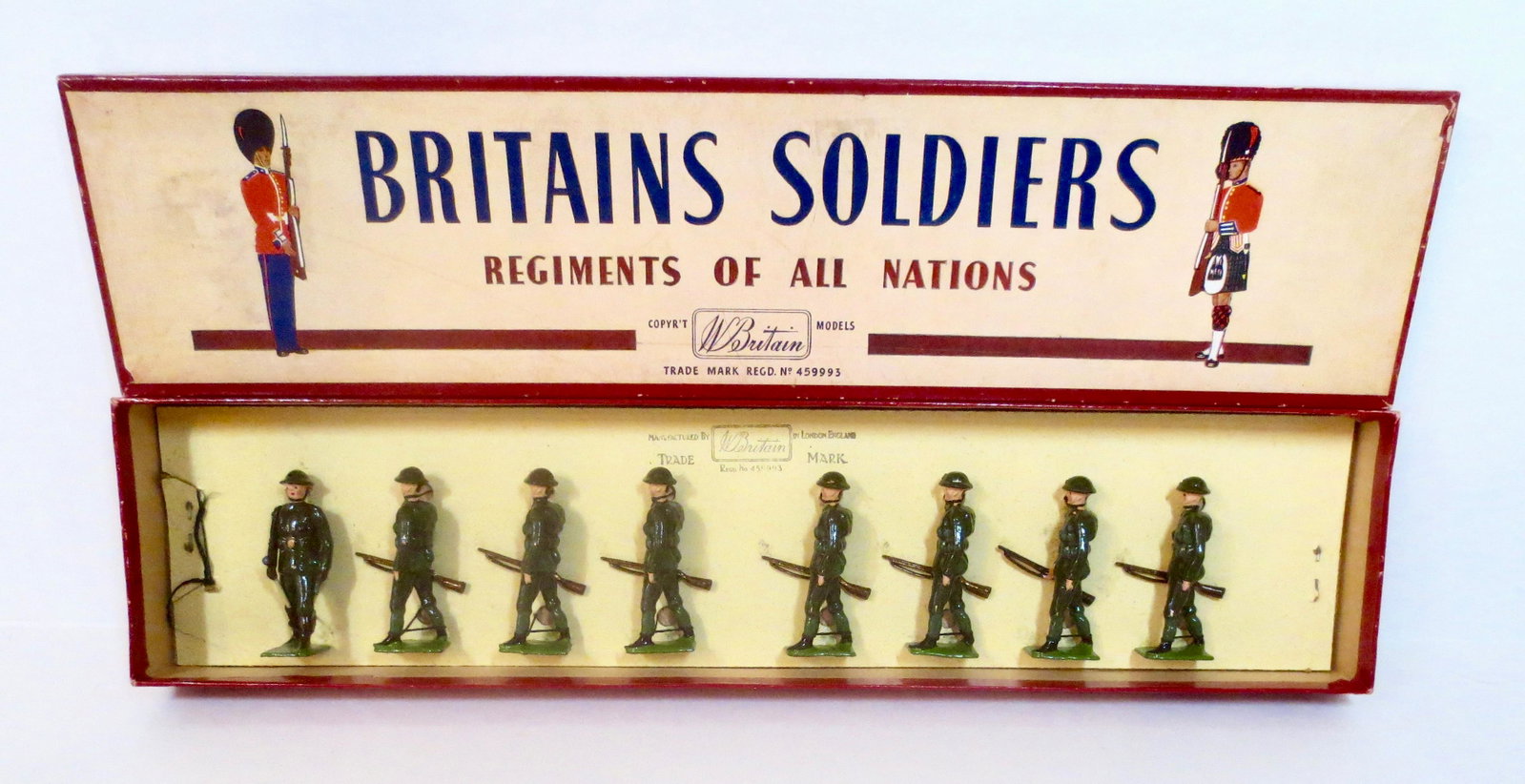 Britains #195 British Infantry: Marching at the Trail. Post war issue. 8 pieces. Mint condition, tied to card in ROAN box. Box very good (side label partially missing).