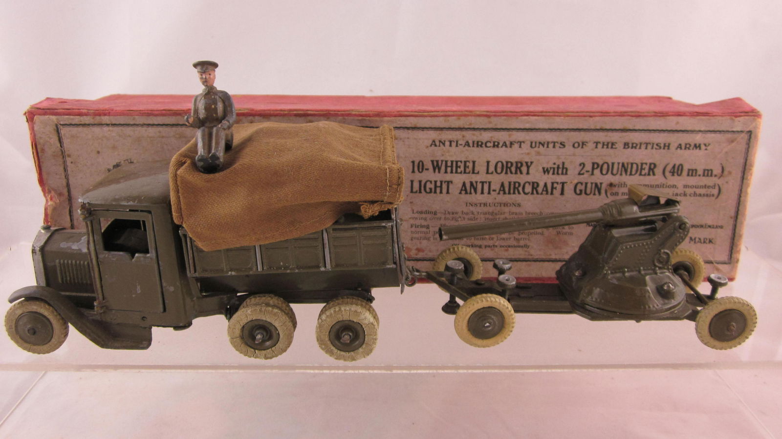 Britains Set #1832 10 Wheel Lorry With Gun.: Boxed 10 Wheel Lorry with 2 pounder gun. 3 pieces, lorry is 1st Version square nose, white treaded tires, offered only 1939-1941. Condition good, large chip on lorry hood, small "V" notch casting flaw