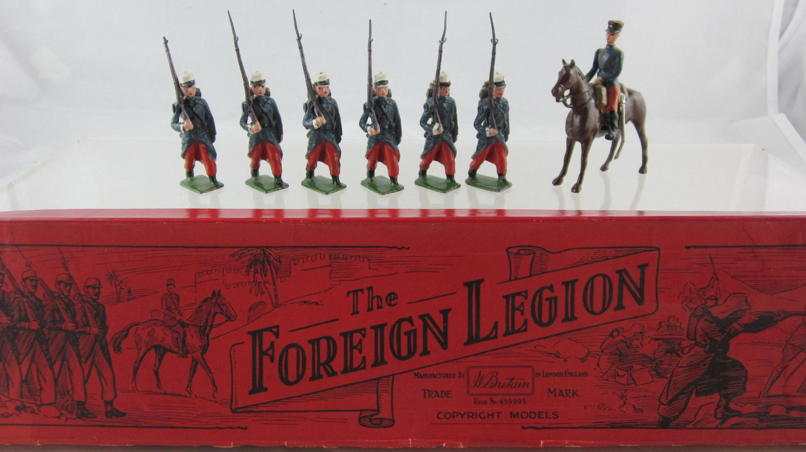 Britains Set #1711 French Foreign Legion.: Boxed French Foreign Legion with Officer. 7 pieces per 1948-1959 issue. Condition very good, 1 bayonet gone. Illustrated unusual red label box is very good, tray has 1 popped corner
