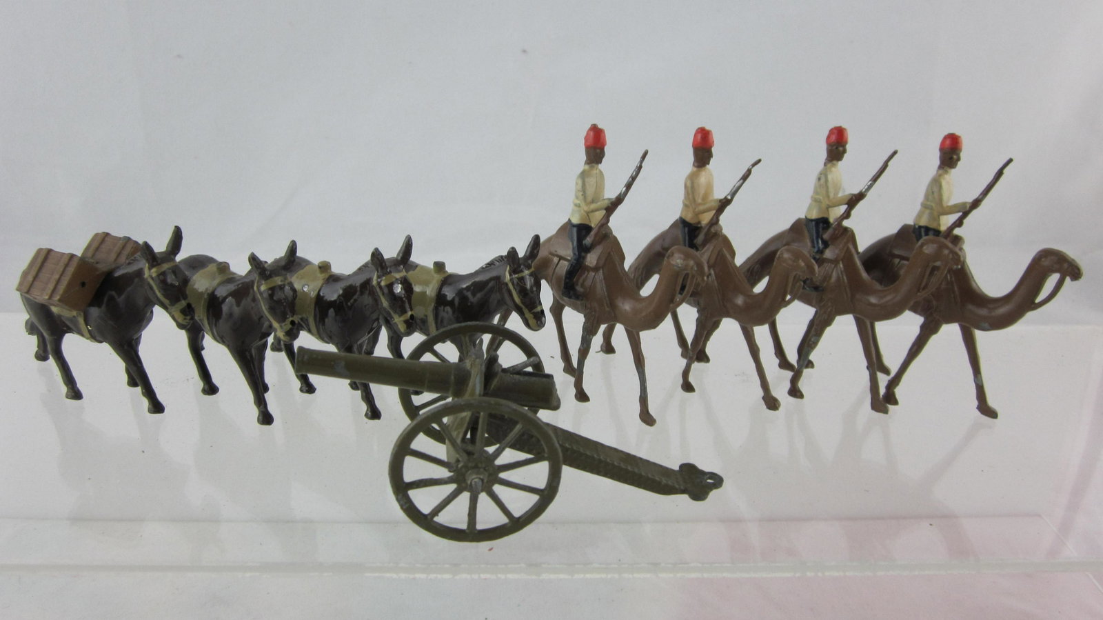 Britains Camels & Johillco Mules Assortment.: UNBOXED Beasts of Burden; 4 of W Series Egyptian Camel Corp (fixed arm smaller scale figures, 4 Johillco mules with 1 packload for Abyssinian Wars, plus 1 #1263 Gun. 10 pieces circa 1930s. Condition e