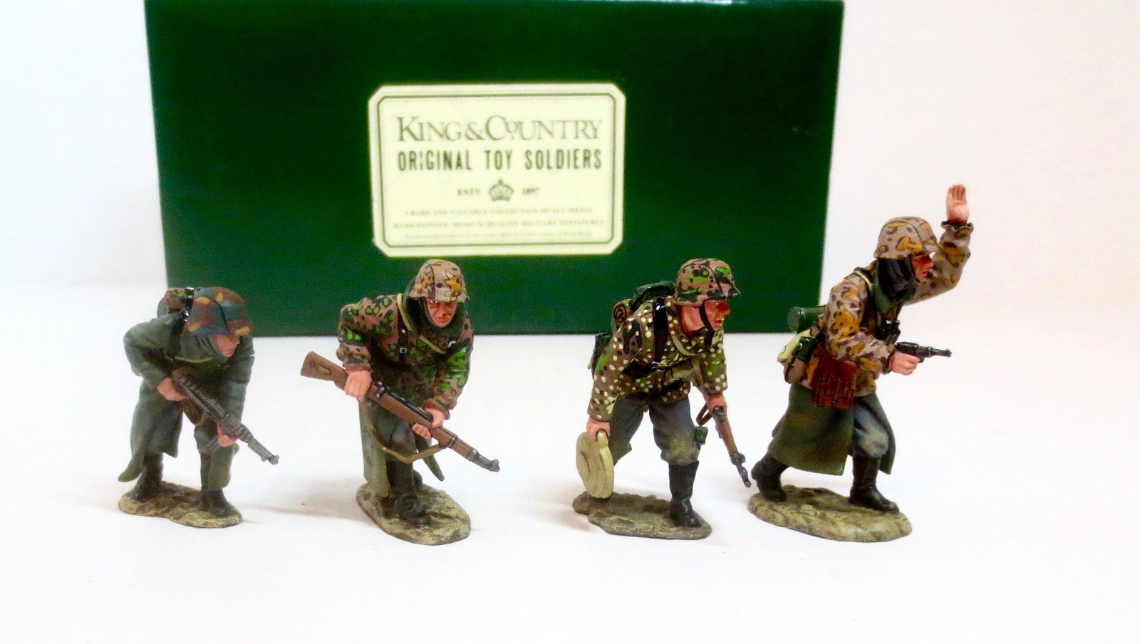 King & Country #WS048 "Advance to Attack": Led by a pistol carrying officer three SS Panzer Grenadiers cautiously move forward. Great detailed coloring on their camouflage smocks and jackets… even the bottom of their great coats is mud and d