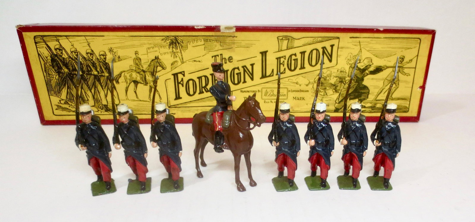 Britains #1711 French Foreign Legion: Foreign Legionnaires, marching at the slope with Mounted Officer. Post war, with illustrated box. 8 pieces. Excellent to good condition (two missing bayonets). Box excellent.