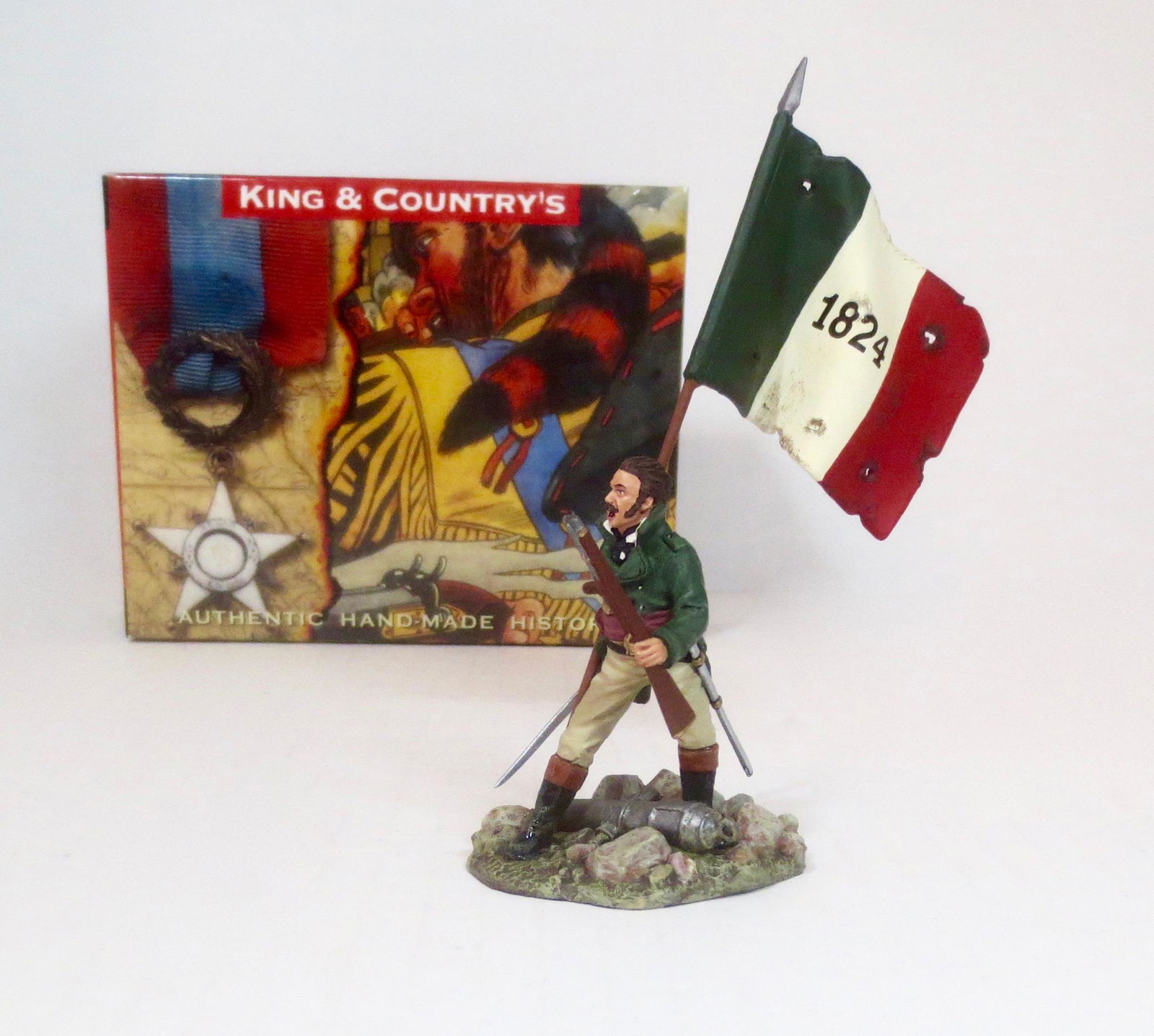 King & Country RTA033 “James Butler Bonham”: Remember The Alamo. “James Butler Bonham” of South Carolina. Bonham stands defiantly, sword in one hand, rifle in the other supporting the “1824” Republic of Texas Flag. Retired Set. Mint cond