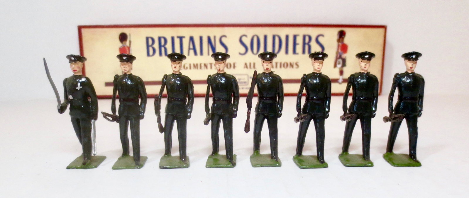 Britains #2091 Rifle Brigade Marching at Trail: Post War issue. 8 pieces. Excellent condition, with original ROAN box. Box excellent (one repaired corner split).
