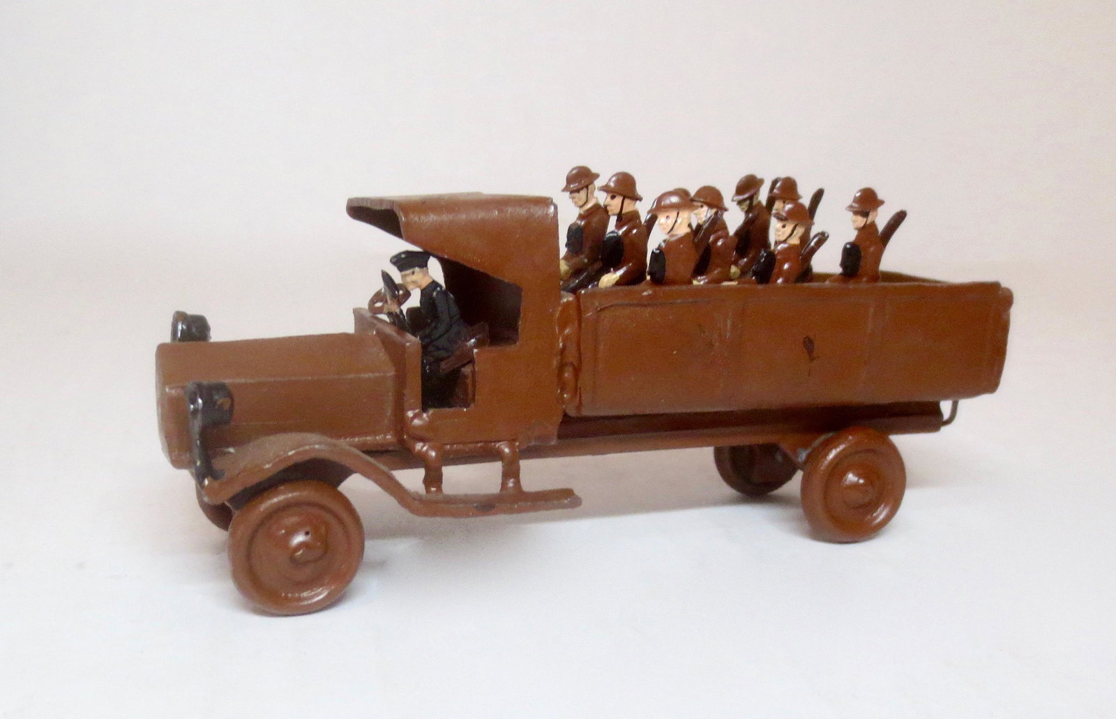 Tin Transport Truck with Crew: Driver and Seated Crew on Benches are removable. Truck measures 4" long. 6 pieces. Excellent condition. Unidentified maker. Unboxed.
