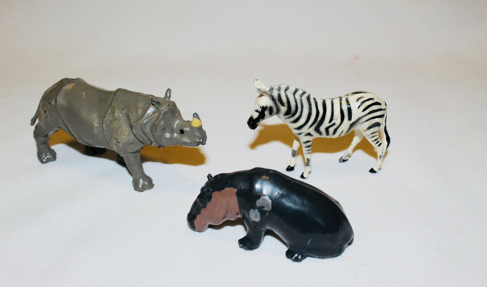 Britains #907 Zebra, #940 Baby Hippo, #960 Rhino: Britains Postwar zoo animals. 3 pieces. Zebra VG/EX, Baby Hippopotamus G/VG, Young Rhinoceros EX. No box.