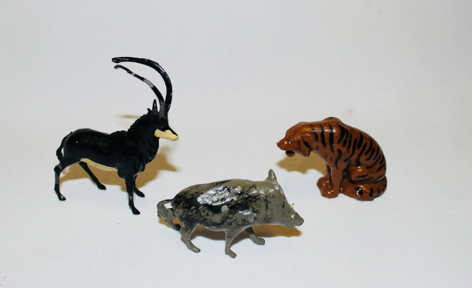 Britains #945 Sable #948 Wart Hog #992 Tiger: Postwar zoo animals. 3 pieces. #945 Sable Antelope VG/EX, #948 Wart Hog poor (hole/dent in right flank), #992 Sitting Tiger EX. No box.