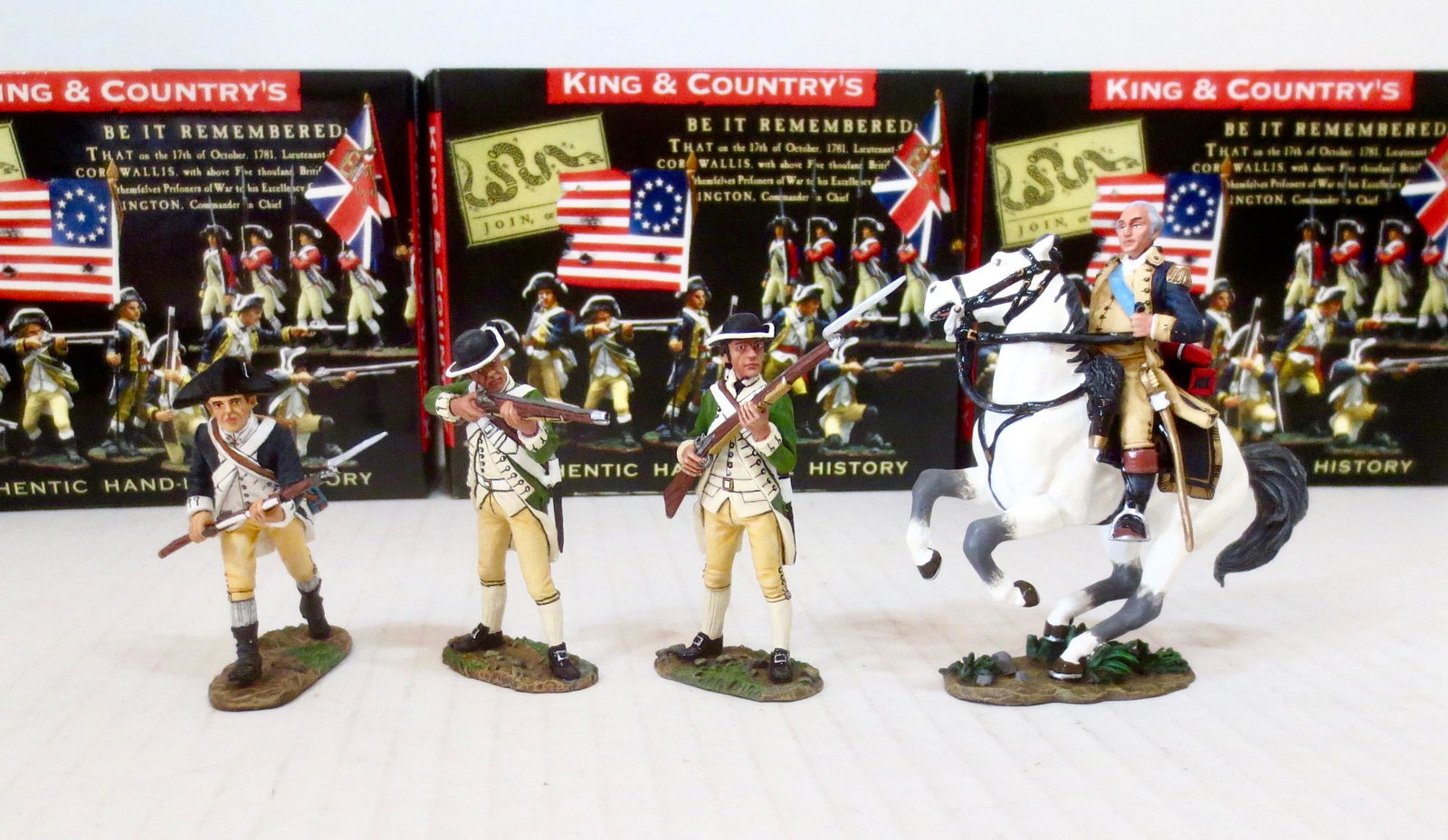 King & Country American Revolutionary War: Includes; #AR064 American Infantry Charging, #AR047 American Marine Standing Ready, #AR045 American Marine Standing Firing. #AR044 George Washington on Horseback. 4 pieces. Near mint condition. Boxes
