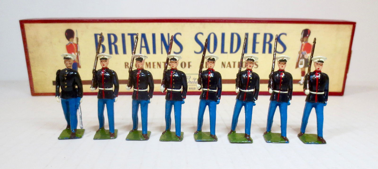 Britains #228 The U.S. Marine Corps: Blue Uniform with Officer. Post war issue, with ROAN box. 8 pieces. Excellent condition. Box excellent.