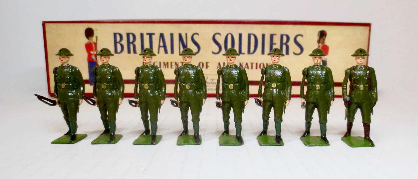 Britains #195 British Infantry: Marching at the Trail. Post war issue, with original ROAN box. 8 pieces. Excellent condition. Box excellent with a bit of fading on the bottom.