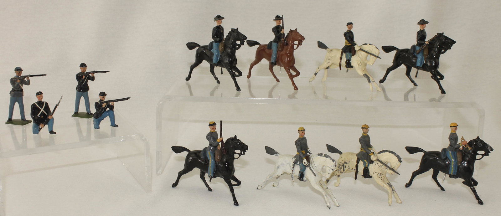 Britains Lot ACW Union and Confederate Cavalry: American Civil War. Union and Confederate Cavalry. Lot includes Confederate Infantry from Set #2055, Union Cavalry from Set #2056 and 4 Infantry Figures. Circa 1950's. 12 Pieces. Condition Good to Ver