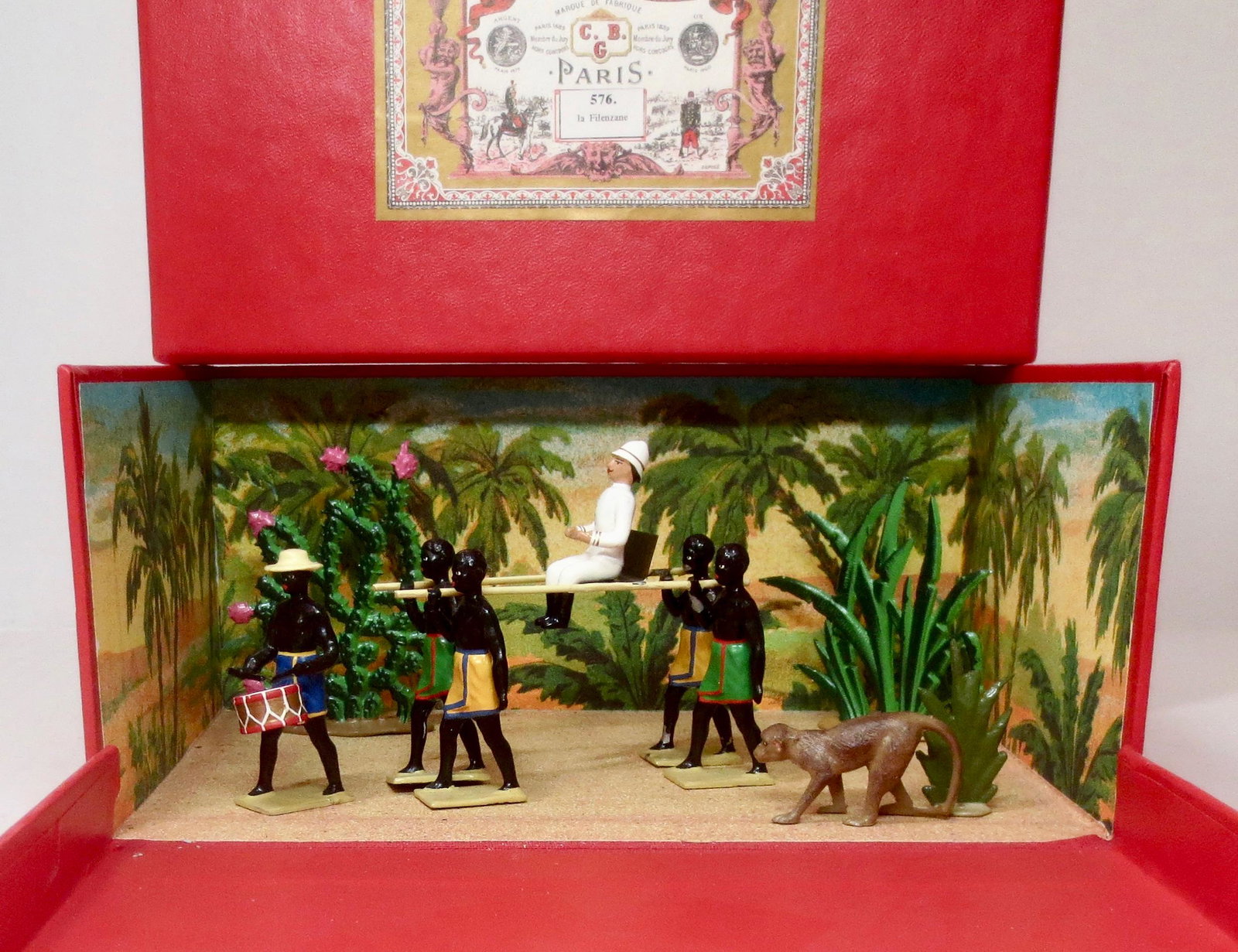 Mignot #576 "la Filenzane" Diorama: Native transport with colonial officer. 11 pieces. Excellent condition (one native loose from carrier pole). Box excellent.