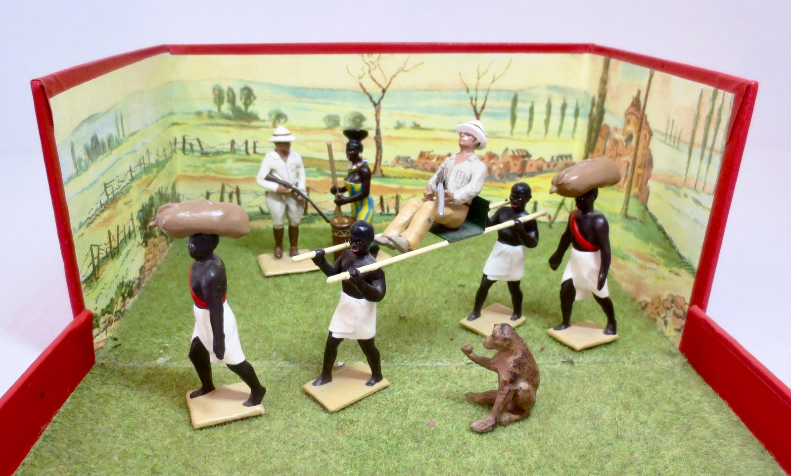 Mignot Hunters in Africa Diorama: Includes; Native Transport, Hunters, Native Girl, and Monkey. 9 pieces. Excellent condition. Box fair (top damaged).