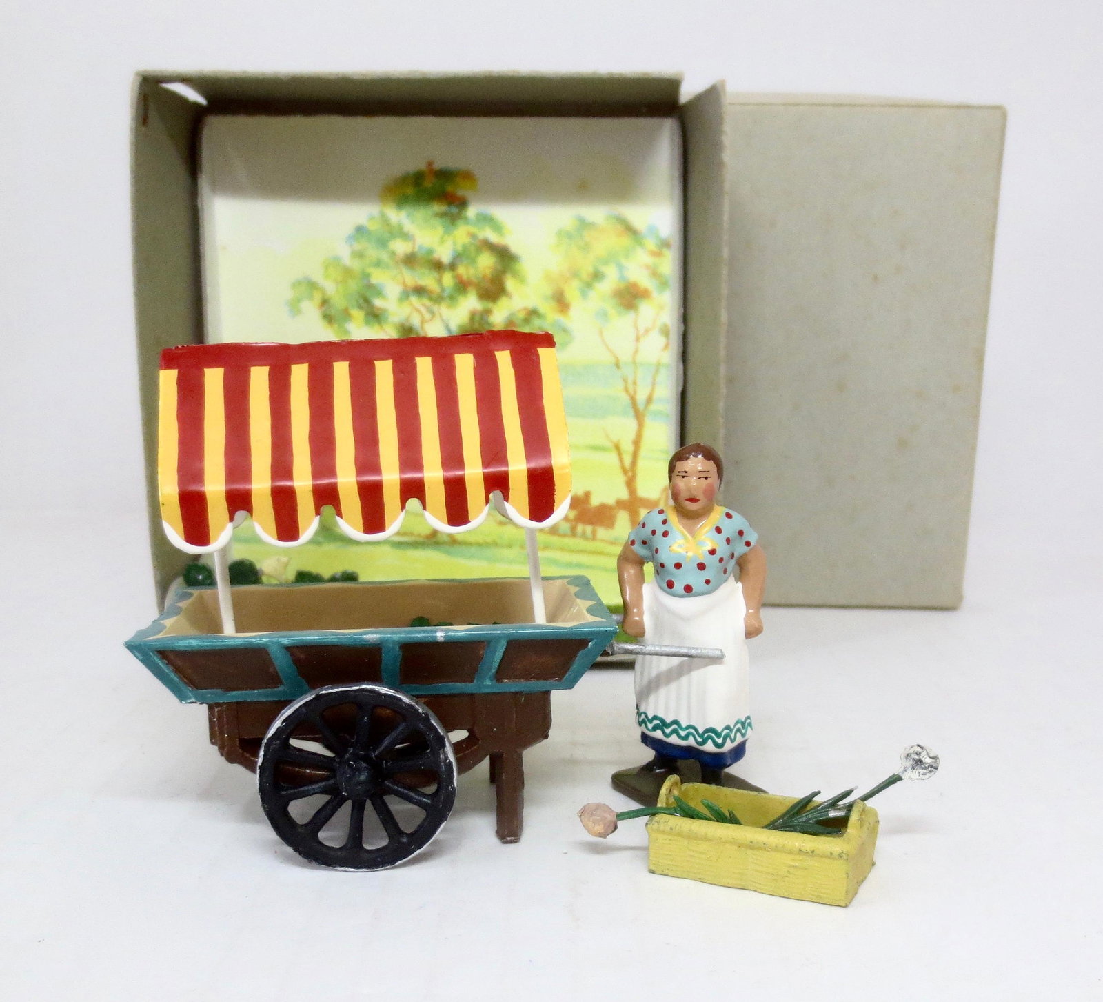 Mignot The Flower Seller Diorama: Scenic boxed set. French merchant with a cart and basket full of flowers. 17 pieces. Near mint condition. Box excellent.