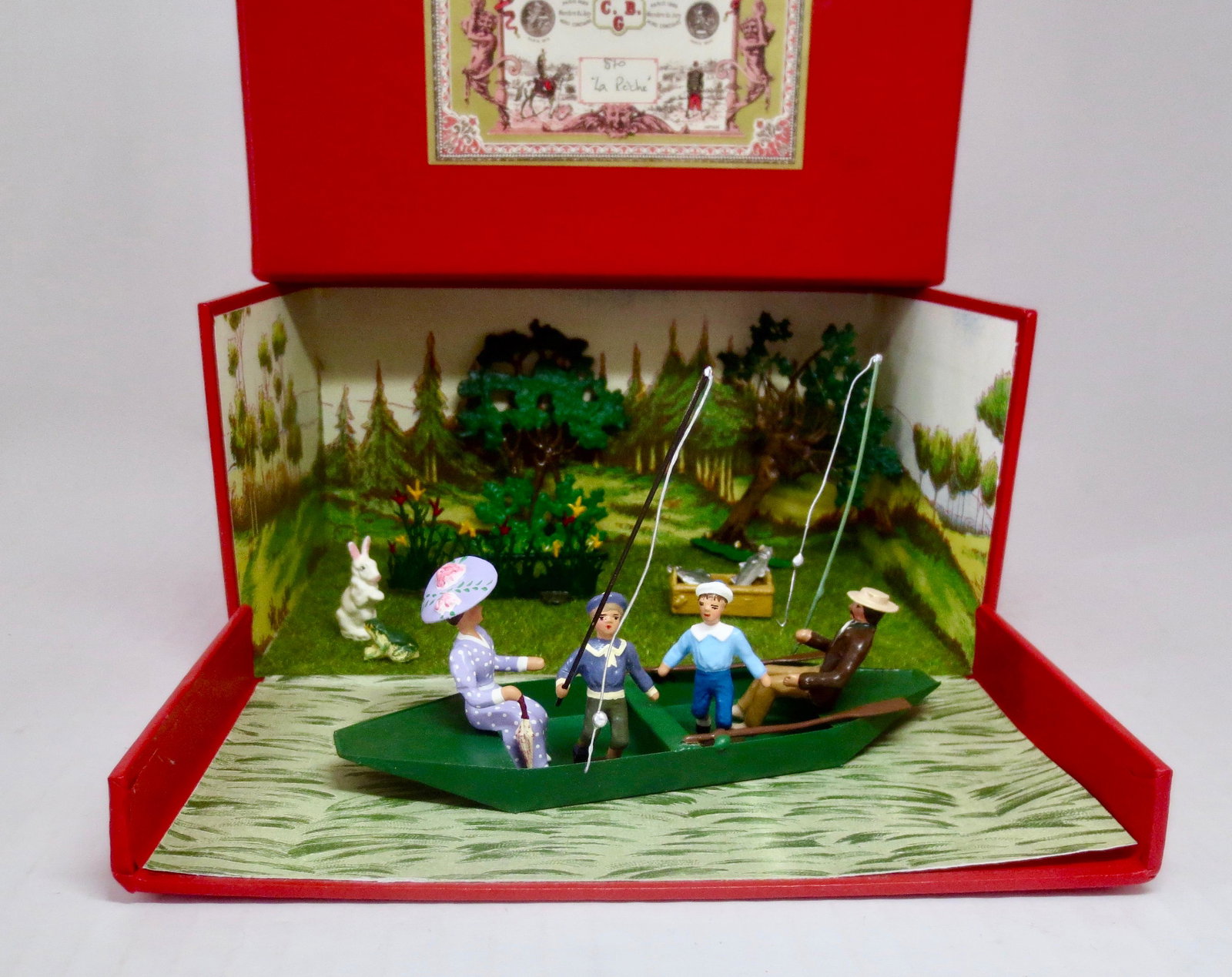 Mignot "la Peche" Diorama: The fishing trip. Lovely scenic boxed set. Includes family fishing in boat, basket of fish, rabbit, toad, snake, trees and flowers. 14 pieces. Near mint condition. Box excellent.