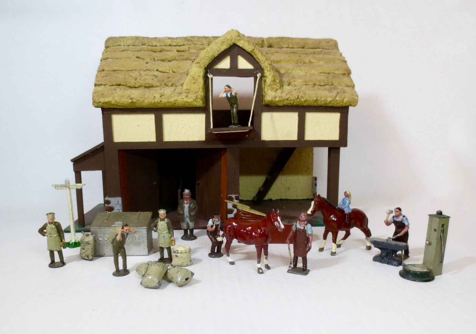 Johillco Farm & Village Assortment: Picturesque assortment includes; Blacksmith and Grainery figures, forge, corn bin, plus farm girl mounted on horse, country gentleman, accessories and wooden two story village building (Building unide