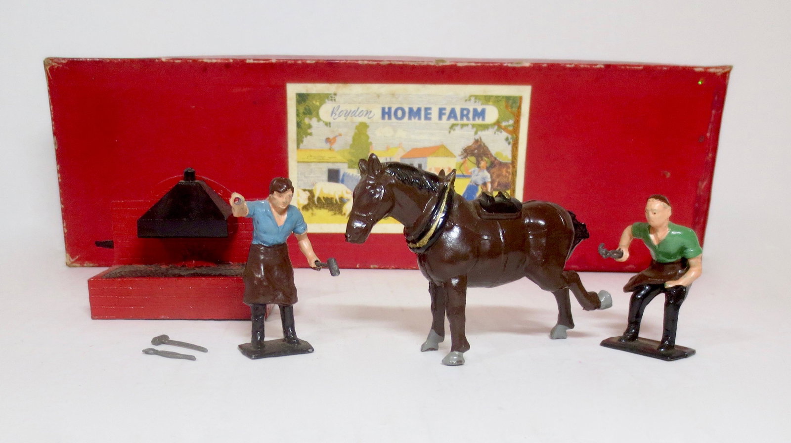 Roydon RARE "Village Blacksmith" Set: From Roydon's Home Farm series. Hard to find set. Includes Blacksmiths, Forge, Horse and scarce tools. 8 pieces. Excellent condition. Box good, with some wear, tear, and stains.