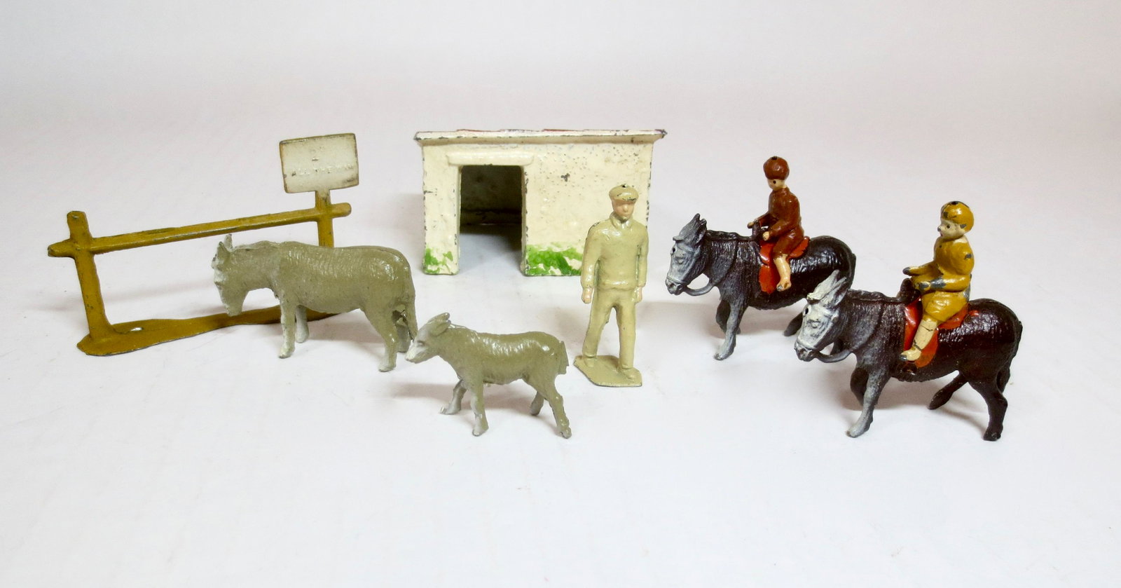 Taylor and Barrett Donkey Ride Set: Whimsical set includes: Fence with "Donkey Rides" sign, Donkey's with Saddles, Mother and Baby Donkeys, Children riders, Stable Building, and Donkey Owner. 9 pieces. Excellent condition. Unboxed.