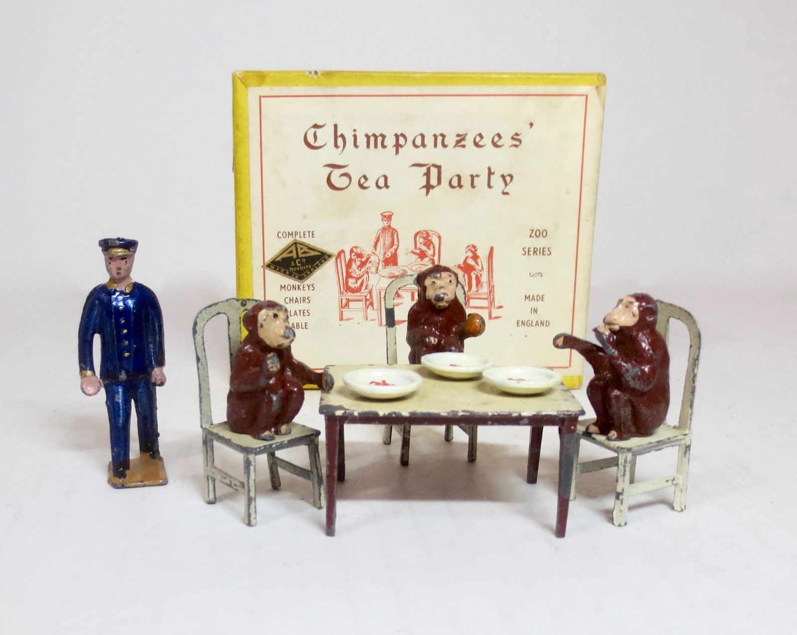 F.G Taylor and Son Chimpanzee Tea Party Set: Rare Zoo boxed series. Includes Monkeys, Chairs, Plates, and Zoo Keeper. 11 pieces. Excellent condition, with a bit of paint loss. Illustrated box excellent.