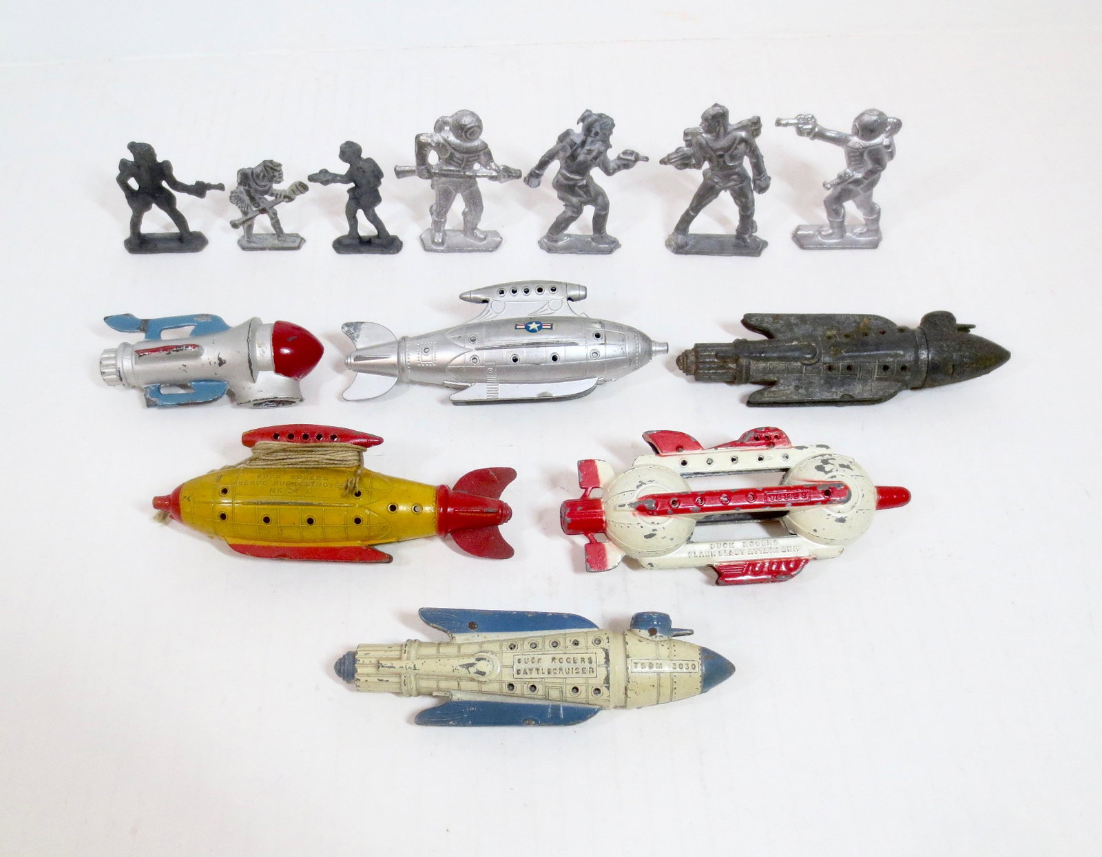 Buck Rogers Space Toy Collection: Includes; two 1937 Tootsietoy Vintage Buck Rogers Venus Destroyers, one Flash Blast Attack Ship, two Battlecruisers, and one Barclay Space Ship, and many Home Cast figures. 13 total pieces. Excellent 