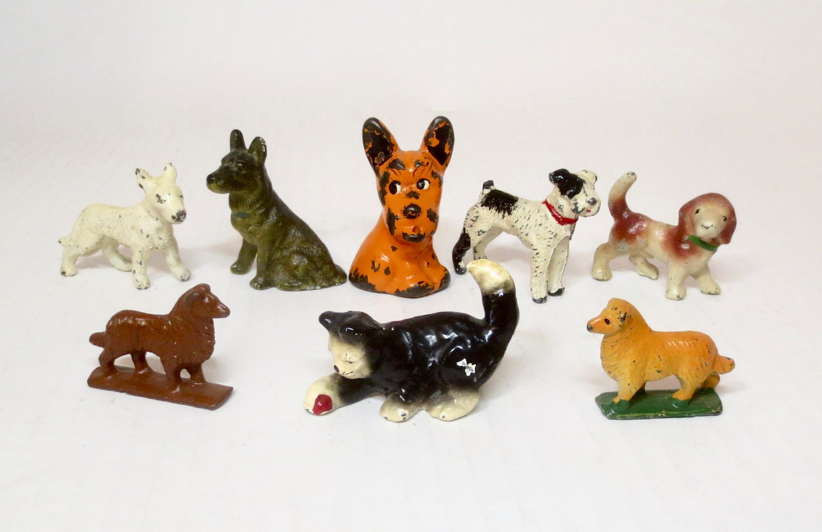 Cast Iron Cat with Dogs Assortment: Includes figures from Hubley, Grey Iron and others. Orange Scottie Dog measures 2-1/4" tall. 8 pieces. Excellent to very good condition. Unboxed.