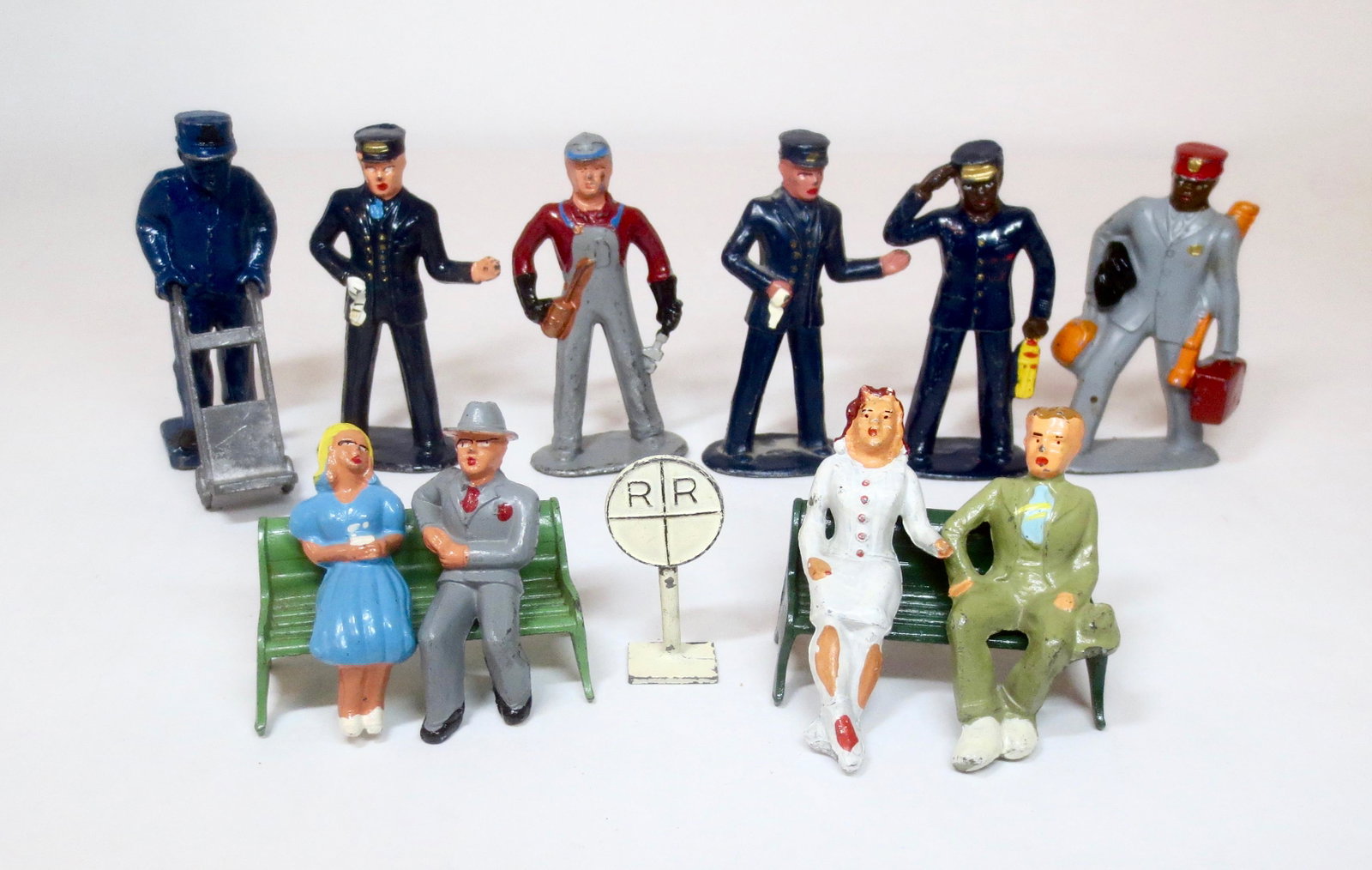 Dimestore Train Crew and Seated Passengers: Fine selection from Barclay and Manoil (solid cast Porter with Dolly from an unidentified maker). 14 pieces. Excellent condition. Unboxed.