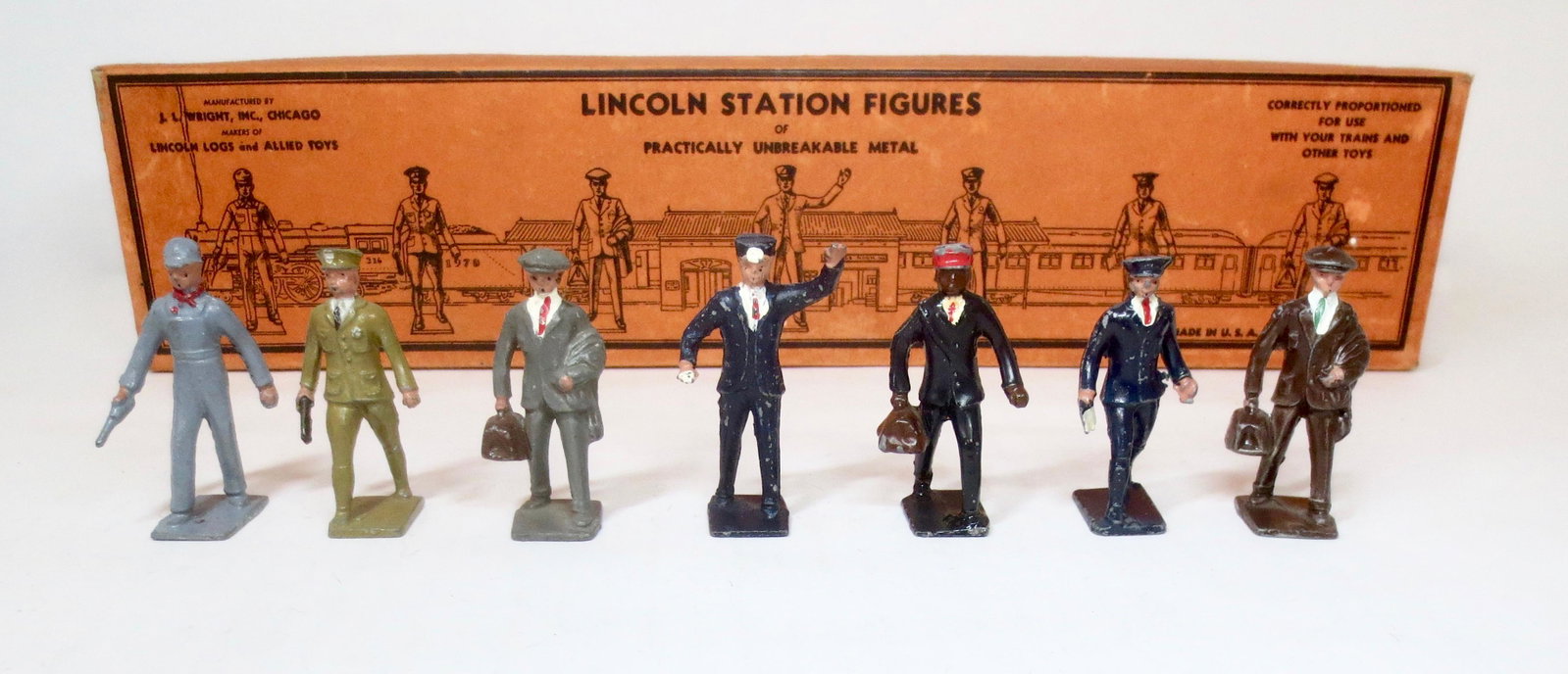 Lincoln Logs #NM-80 Station Figures: Includes two Passengers, Engineer, Conductor, Red Cap Porter, Policeman, and Messenger. Excellent condition. Illustrated box excellent.