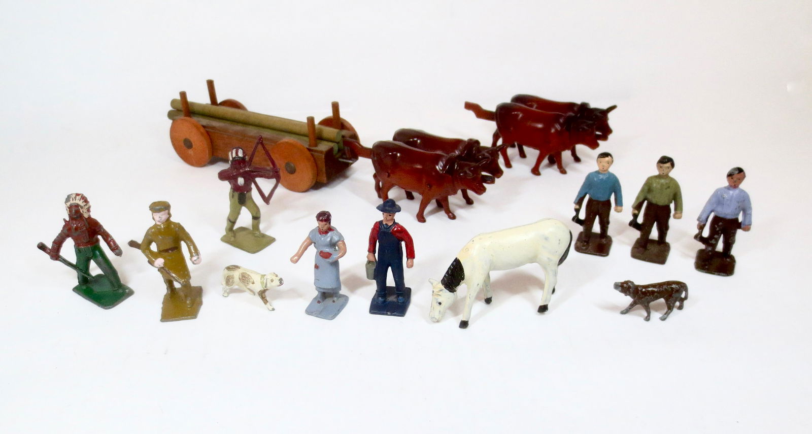 Lincoln Logs Pioneer & Settlers Assortment: Includes two Oxen teams (one with broken hitch), wagon load of timbers, Indians, Dogs, Farmer and Wife, Horse, and Abe Lincoln (three paint variants). 14 total pieces. Unboxed.