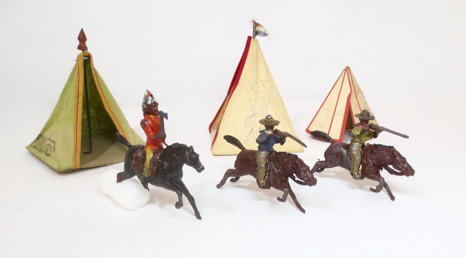RARE Pre war Reka Wild West figures: Two scarce mounted Cowboys firing carbines and a mounted Indian Chief with Hatchet. Plus three early Teepees from various makers. Very good to good condition (Indian's horse missing one hind leg). Unb