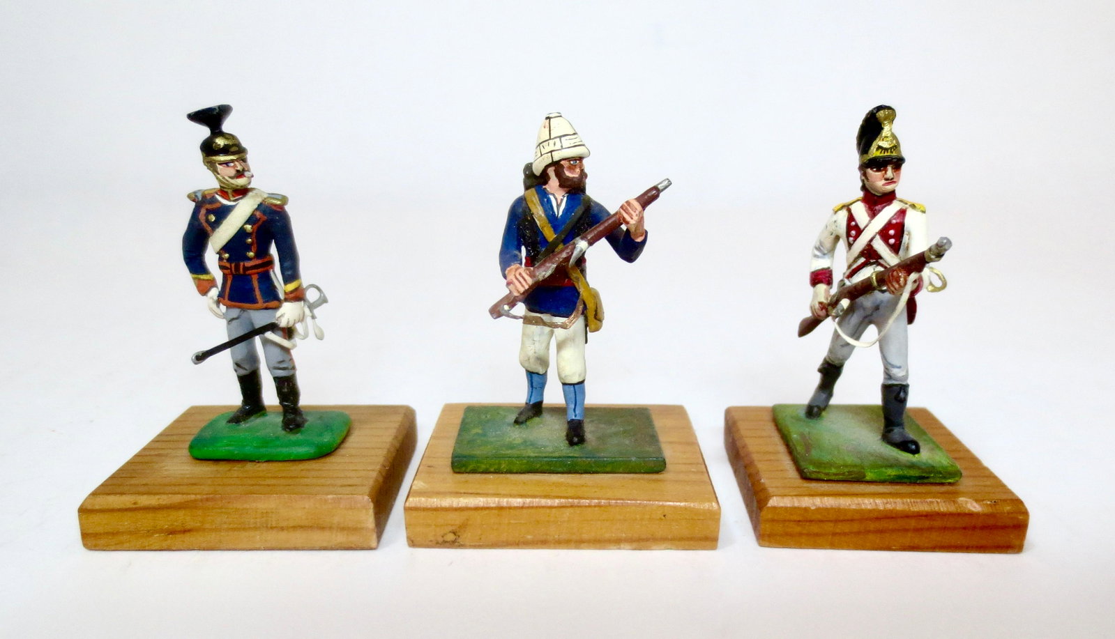 Historical Miniatures Trio of Soldiers: Fine variety of unique commissioned 40mm figures on wooden bases. Circa 1956-1957. Includes; Lieutenant of the 14th Prussian Ulans 1900, Infantry man in Tropical Helmet, and 11th Bavarian Fusilier of 