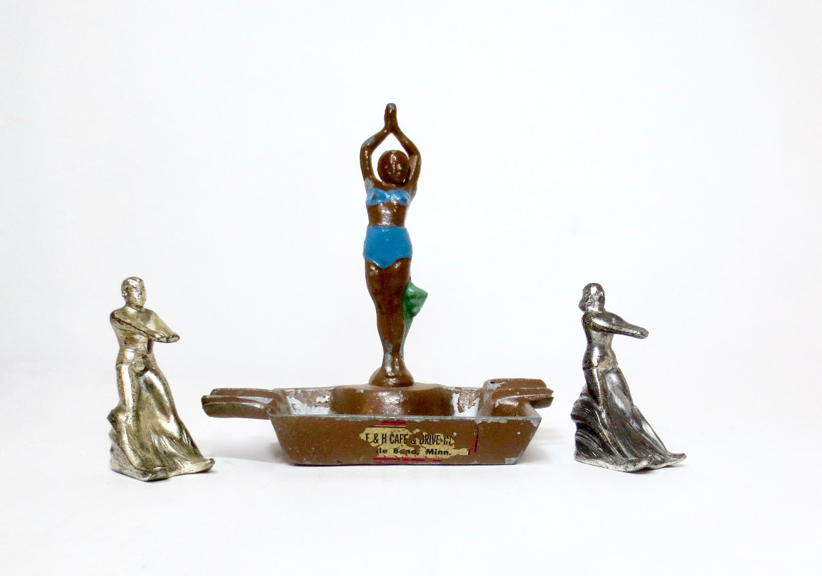 Souvenir Ashtray and Water Skiers: E&H Café and Drive Inn souvenir ashtray, with Boy and Girl Water Skiers. 2" to 4" tall. Excellent to very good condition. Unboxed.