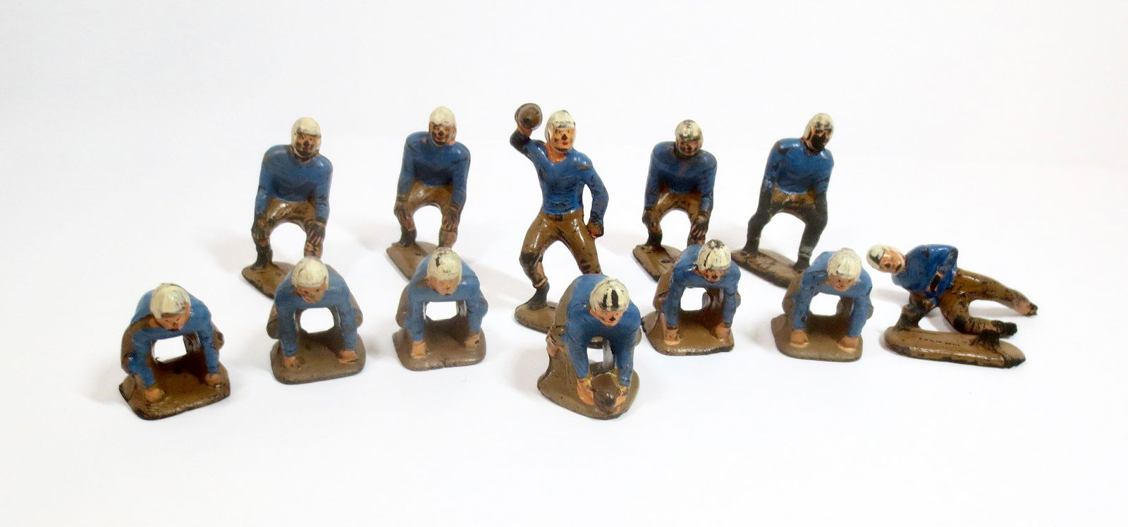 Auburn Rubber Football Team: Linemen, Center, QB and Running Backs in Blue uniforms. 12 pieces. Good to fair condition (some paint wear, cracks, and one broken off of base). Unboxed.