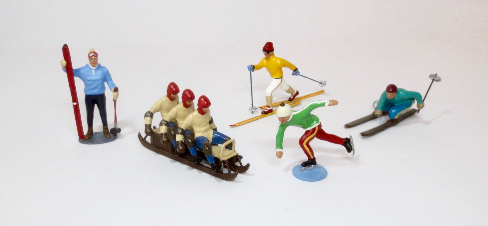 C.B.G. Mignot Winter Sports Assortment: Bob Sledders, Skiers and Skaters. 5 pieces. Near mint condition. Unboxed.