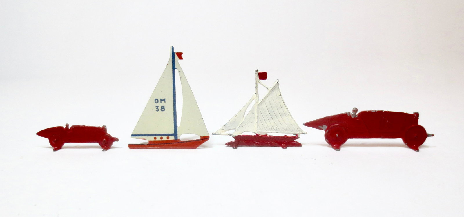 Britains RARE Yacht and Motor Race Assortment: Mid 1930's pieces. Two Britains Race cars #29D and #33D, and one Yacht #30D. See page 237 of Joplin's "Britains Civilian Toy Figures" Book. Plus unidentified orange yacht. 35mm to 55mm long. 4 pieces.