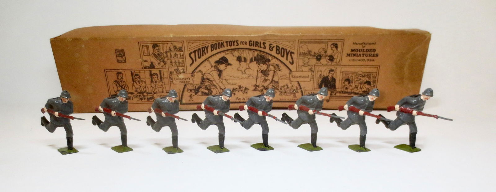 Jones #2901IG German Infantry of 1940: Charging with Bayonets. 8 pieces. Near mint to excellent condition, with original "Story Book Toys for Girls and Boys" illustrated label box. Box good, with some wear and one top side tear.