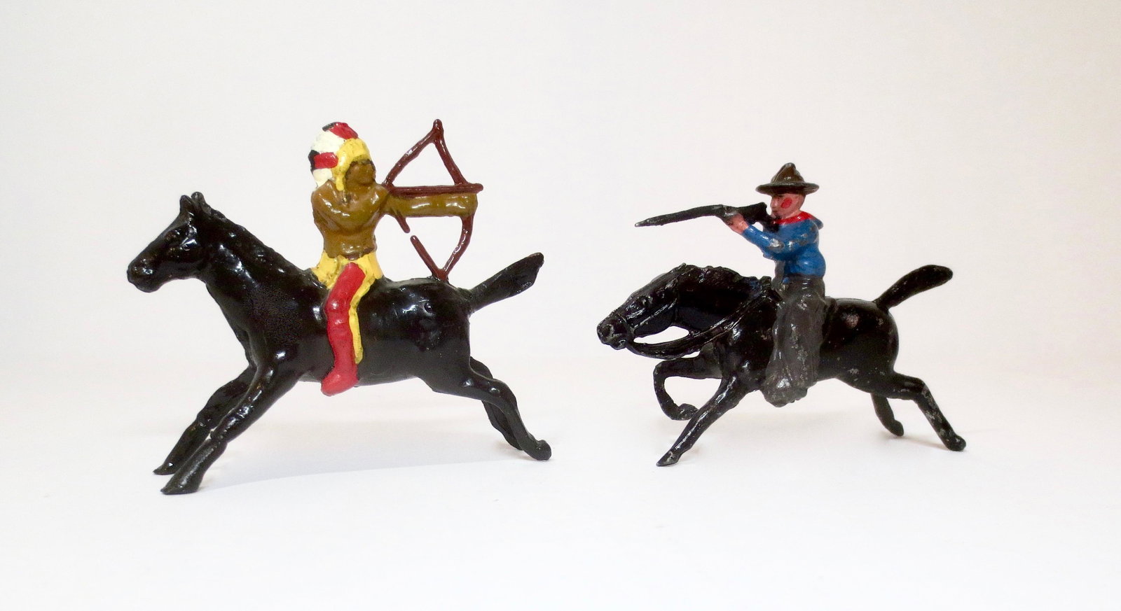Jones Mounted American Cowboy and Indian: Sioux Indian of 1876 firing bow, and Cowboy firing rifle. 54mm. 2 pieces. Excellent condition. Unboxed.