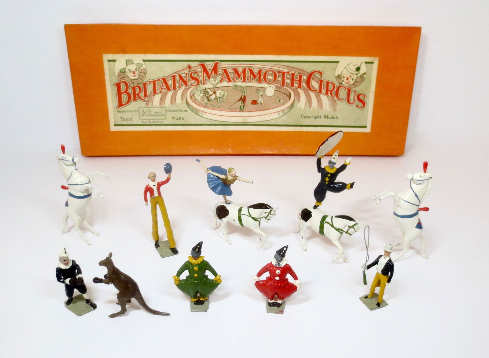 Britains #2054 Mammoth Circus: Clowns, Equestrienne, Boxing Kangaroo, Liberty Horses and Trainer. Circa 1951-1961. 12 pieces. Excellent condition. Box fair (top side split, and bottom end split).