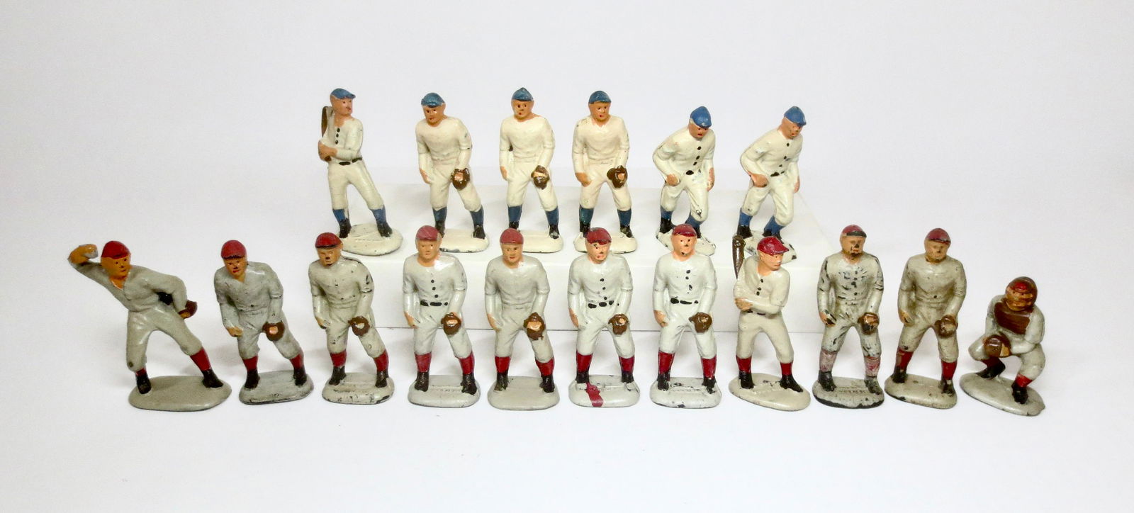 Auburn Rubber Baseball Players: Pitcher, Batters, Catcher and Fielders. Six Blue, and eleven Red. 3" tall. 17 pieces. Fair condition, with paint loss. Unboxed.
