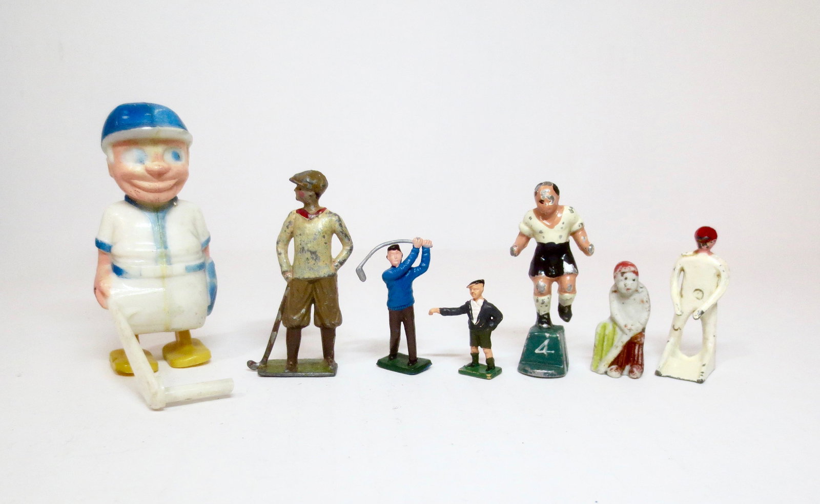 Sports Figure Collection: Baseball Ramp Walker, Golfers, Rugby Player and Cricketeers (one porcelain, and one metal). Assorted makers. 7 pieces. Excellent to very good condition. Unboxed.
